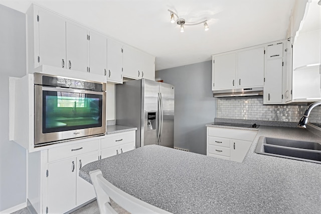 kitchen featuring a sink, white cabinets, backsplash, and stainless steel appliances