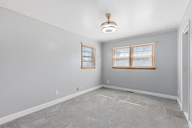 carpeted empty room with baseboards