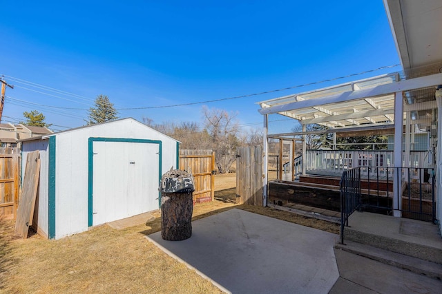 view of shed with fence and a pergola