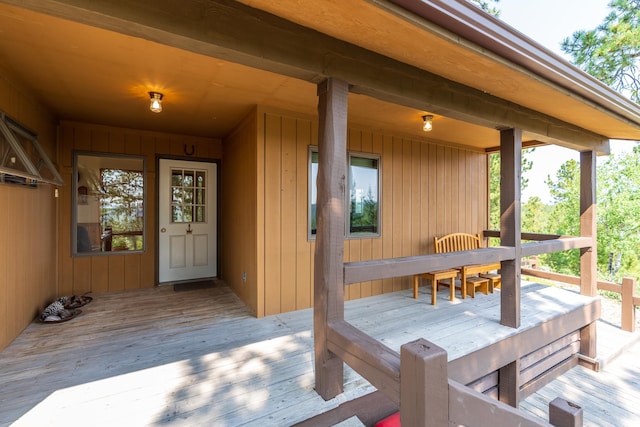 wooden deck featuring outdoor dining area