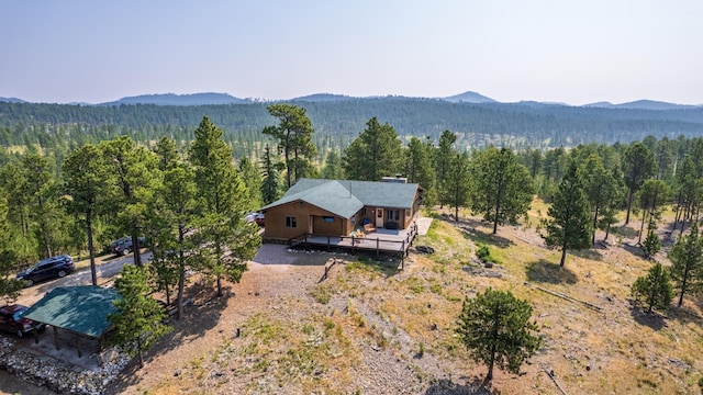 aerial view with a mountain view and a forest view