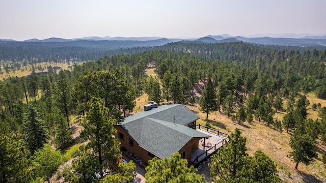 drone / aerial view featuring a mountain view and a forest view