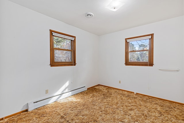 carpeted empty room with a baseboard radiator, baseboards, and visible vents