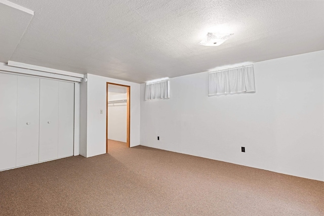 unfurnished bedroom with a textured ceiling and carpet floors