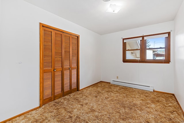 unfurnished bedroom featuring a baseboard radiator, baseboards, carpet, and a closet