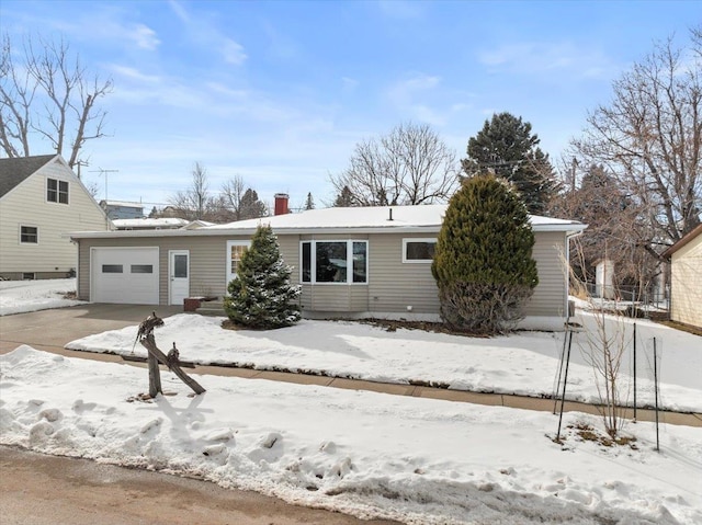 view of front of property featuring an attached garage and a chimney