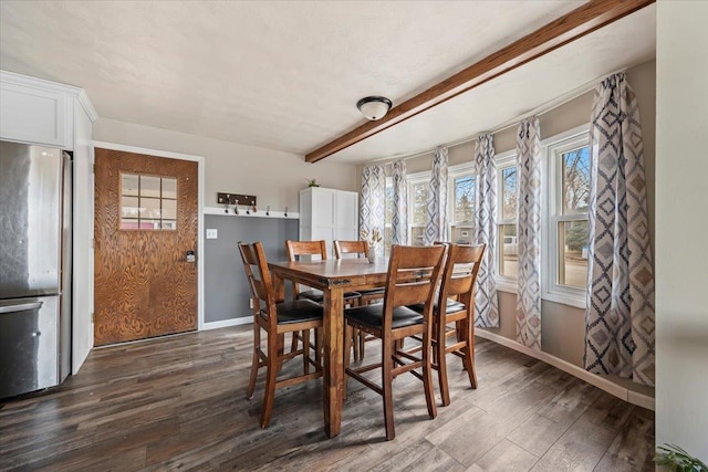 dining room with dark wood-style floors, beamed ceiling, and baseboards