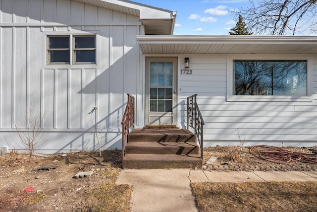 view of exterior entry with board and batten siding