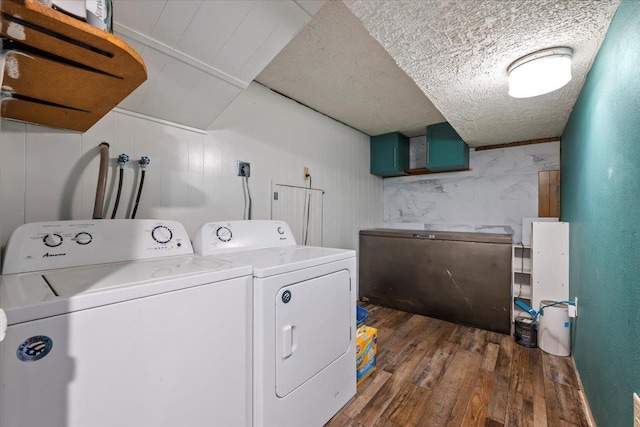 laundry room with wood finished floors, laundry area, and washer and clothes dryer