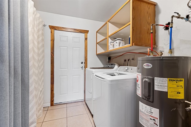 washroom with separate washer and dryer, electric water heater, light tile patterned flooring, and laundry area