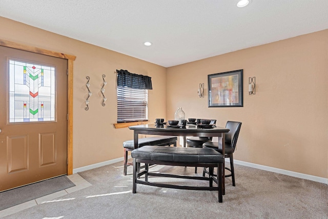 dining room featuring light carpet, recessed lighting, and baseboards