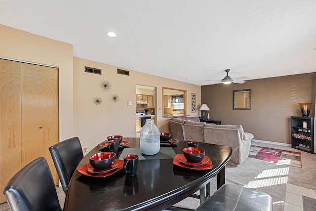 dining space featuring visible vents, baseboards, carpet, and ceiling fan