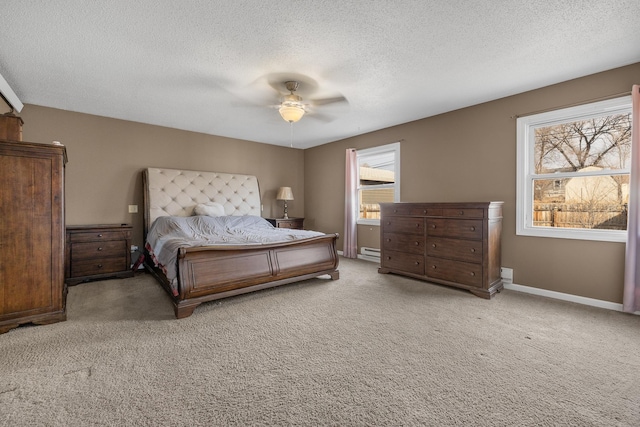 carpeted bedroom featuring a ceiling fan, baseboards, and a textured ceiling