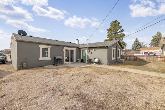 back of house featuring a patio, cooling unit, fence, and stucco siding