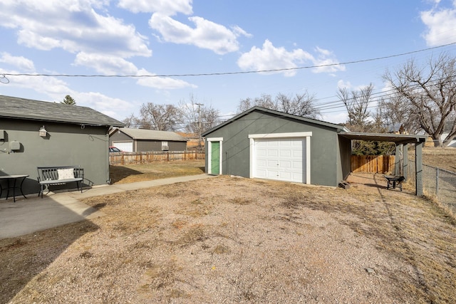 garage with fence and driveway