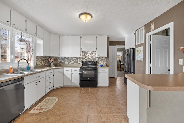 kitchen with tasteful backsplash, light tile patterned floors, white cabinets, stainless steel appliances, and a sink