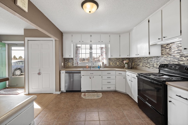 kitchen with electric range, white cabinets, a sink, and stainless steel dishwasher