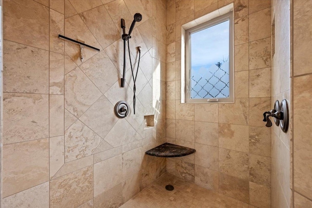 full bathroom with a tile shower