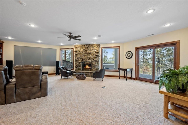 living room with carpet, a fireplace, visible vents, and baseboards