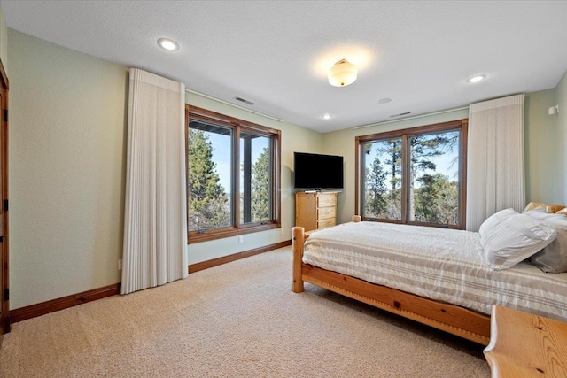 carpeted bedroom with recessed lighting, visible vents, and baseboards