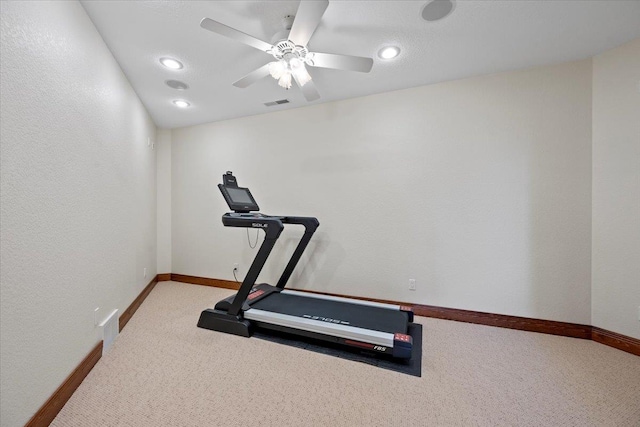 workout room featuring visible vents, a ceiling fan, baseboards, and carpet floors