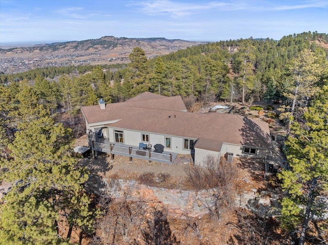 birds eye view of property with a mountain view and a wooded view