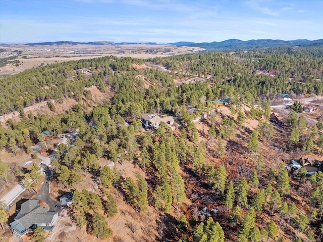 bird's eye view with a mountain view and a wooded view