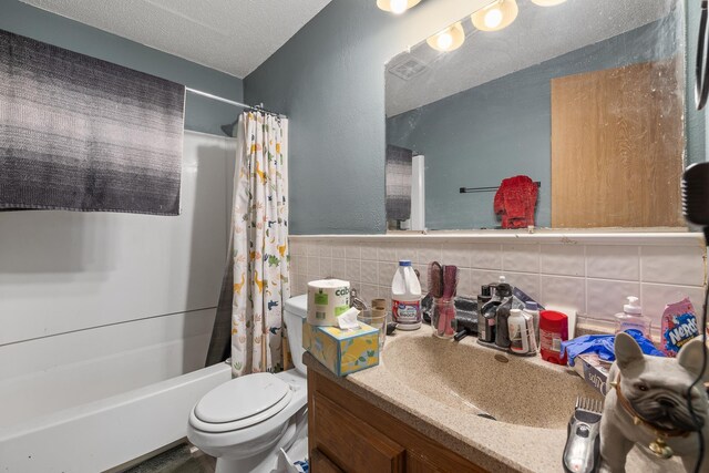 621 Other, Rapid City, SD 57701 - bathroom featuring shower / bathtub combination with curtain, toilet, a textured ceiling, tile walls, and vanity
