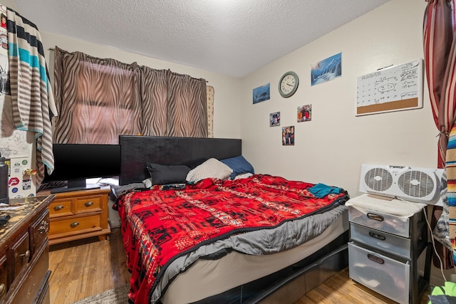 621 Other, Rapid City, SD 57701 - bedroom featuring a textured ceiling and wood finished floors