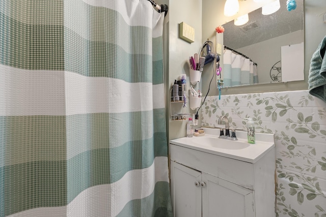 621 Other, Rapid City, SD 57701 - bathroom with vanity, curtained shower, visible vents, and a textured ceiling