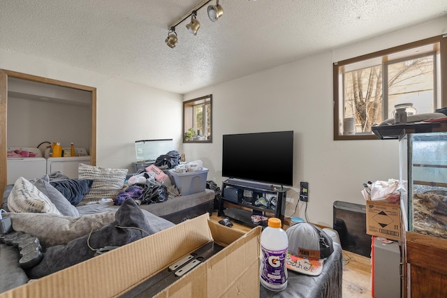 621 Other, Rapid City, SD 57701 - living room with light wood-style floors, a textured ceiling, independent washer and dryer, and rail lighting