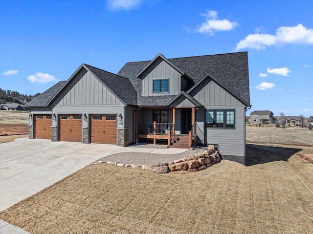 view of front of property with board and batten siding, a porch, concrete driveway, a garage, and stone siding