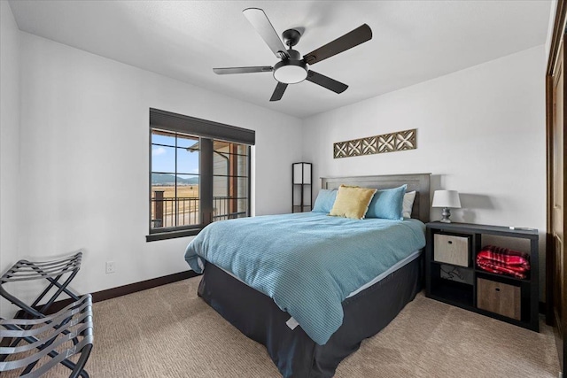 bedroom featuring baseboards, carpet floors, and a ceiling fan