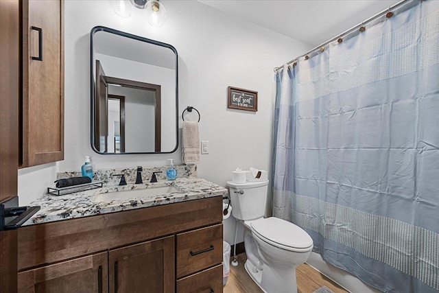 full bath with a shower with shower curtain, toilet, vanity, and wood finished floors