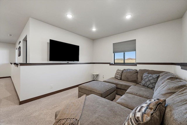 carpeted living area featuring recessed lighting and baseboards