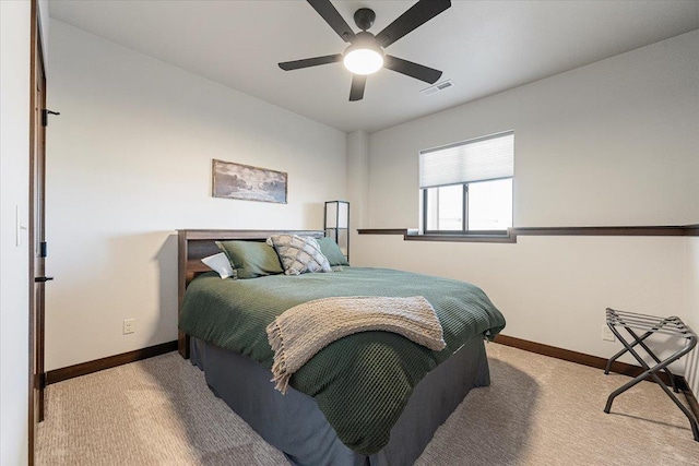 bedroom with visible vents, light carpet, baseboards, and ceiling fan