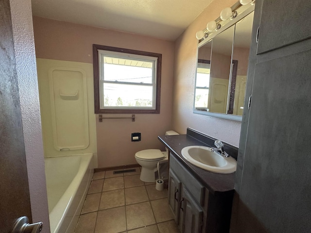 bathroom with vanity, a tub to relax in, visible vents, baseboards, and tile patterned floors