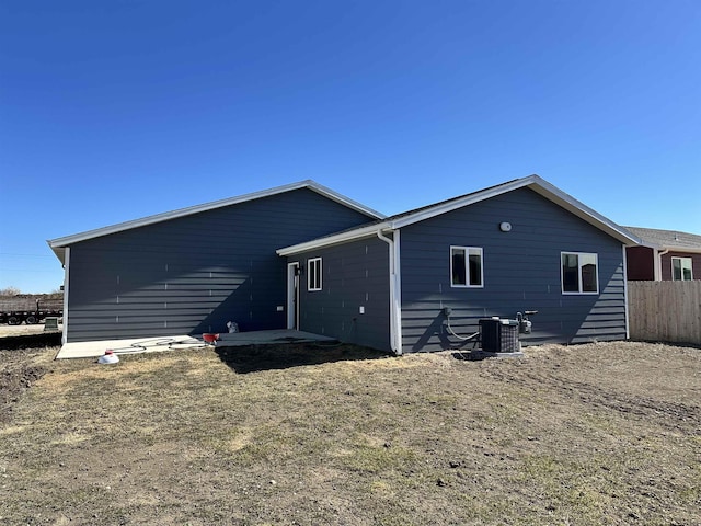 back of house featuring a patio area, central AC unit, and fence