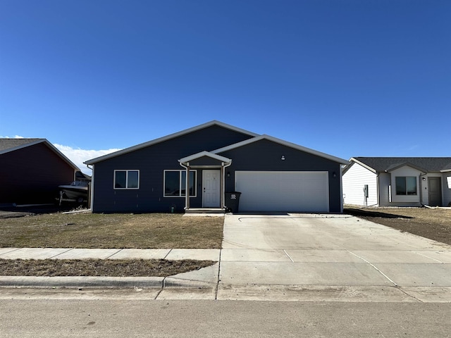 ranch-style home featuring a garage and driveway