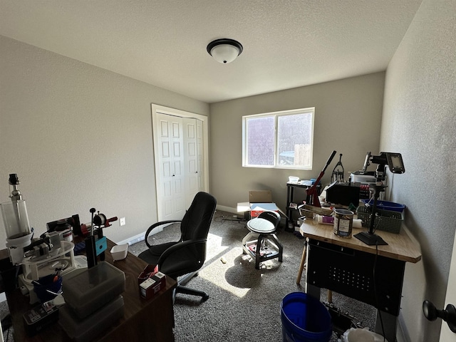 home office featuring baseboards, carpet floors, a textured ceiling, and a textured wall