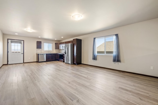 427 Diamond Ridge Blvd, Rapid City, SD 57703 - unfurnished living room with recessed lighting, baseboards, a healthy amount of sunlight, and light wood-style flooring