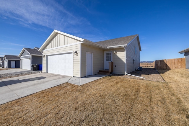 427 Diamond Ridge Blvd, Rapid City, SD 57703 - view of front of property with fence, concrete driveway, a front lawn, a garage, and board and batten siding