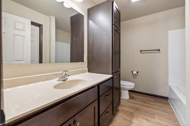 427 Diamond Ridge Blvd, Rapid City, SD 57703 - full bathroom with baseboards, a washtub, toilet, wood finished floors, and vanity