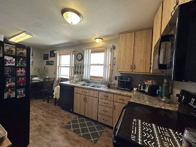 109 David Dr, Sturgis, SD 57785 - kitchen with a sink, a textured ceiling, black appliances, and dark wood finished floors