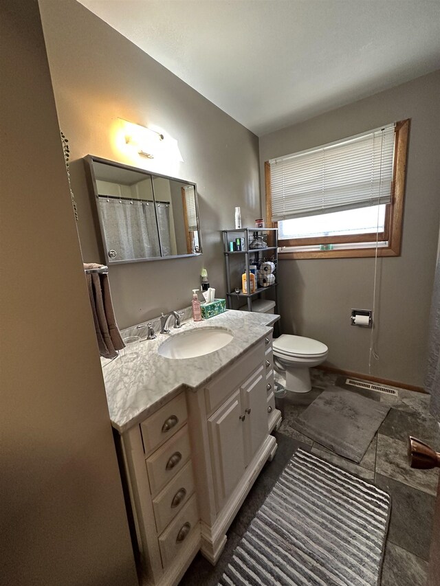 109 David Dr, Sturgis, SD 57785 - full bath featuring visible vents, toilet, vanity, and baseboards