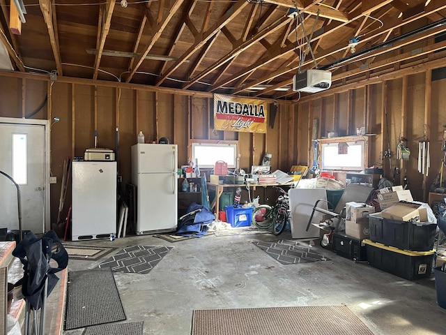 109 David Dr, Sturgis, SD 57785 - garage with a garage door opener and freestanding refrigerator