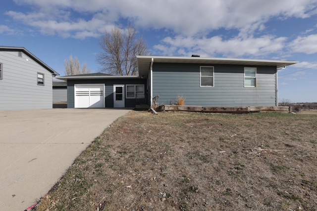 view of front facade with concrete driveway and a garage