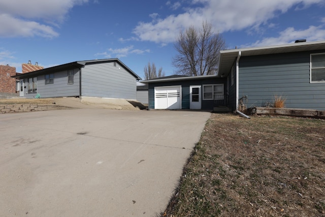 rear view of property with concrete driveway