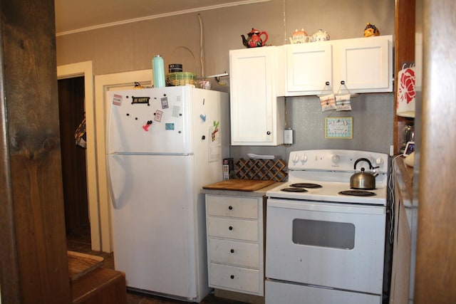 kitchen with white appliances, white cabinets, and light countertops