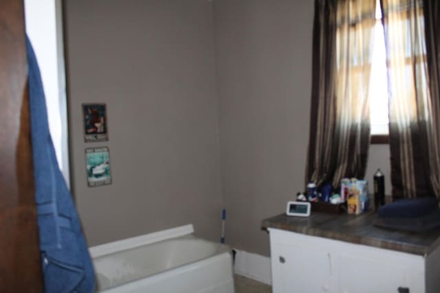full bath featuring vanity and a bathing tub